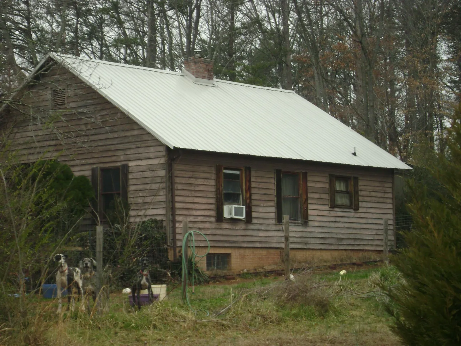 White metal roof on an old wood sided farmhouse, from a Metal Roof Installation job in Temple City